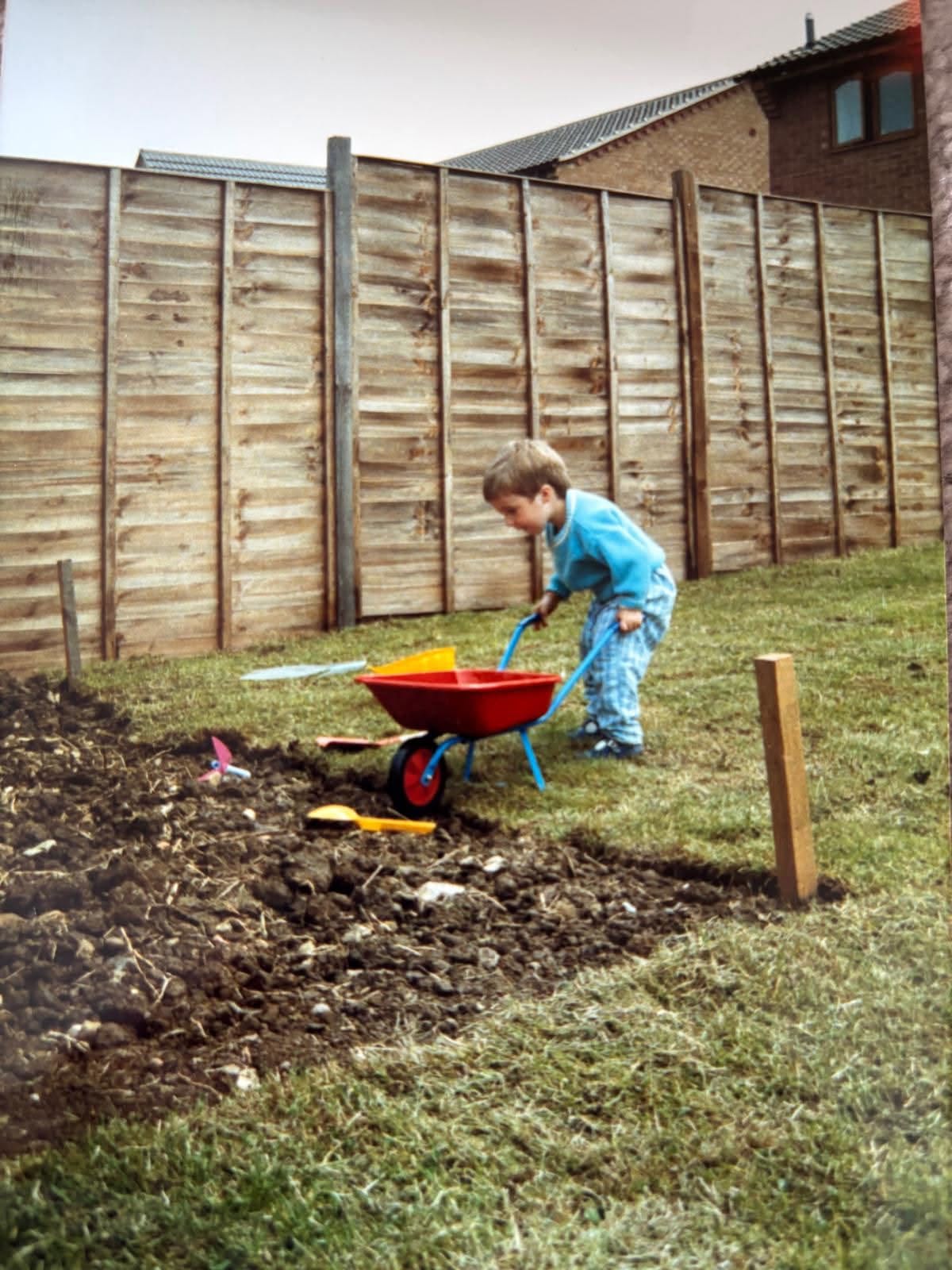James helping in his parents' garden as a child